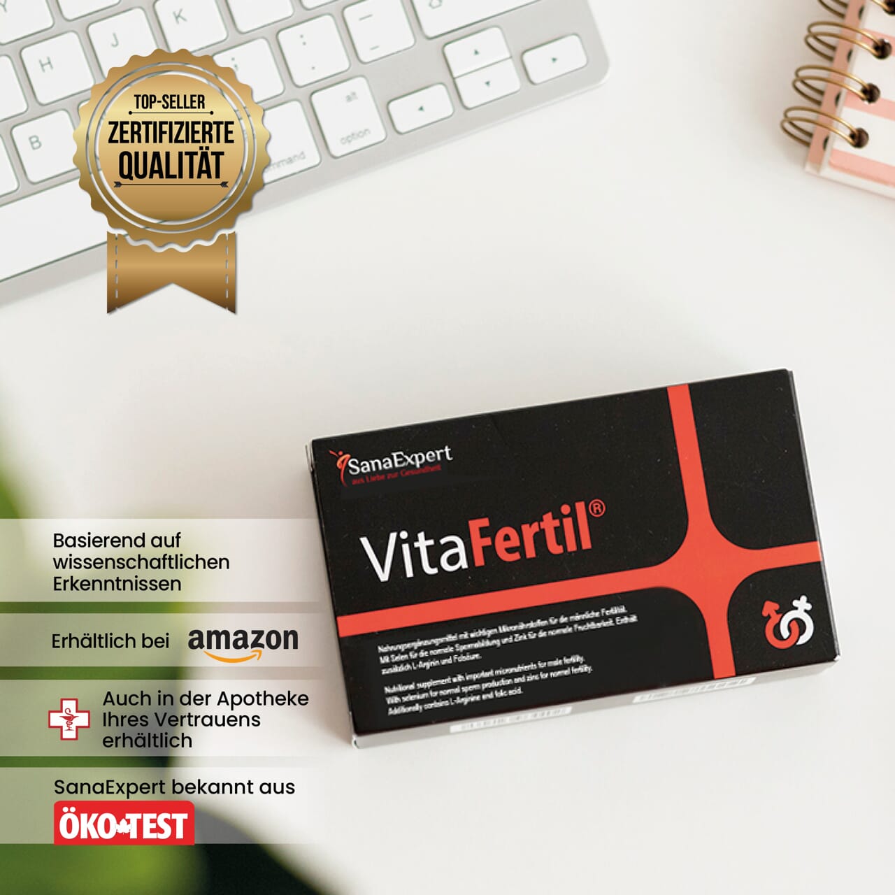 Packung VitaFertile vor einer Tastatur, das Zertifikat für Qualität prominent im Vordergrund, auf weißem Untergrund.